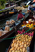 Thailand, Locals sell fruits, food and products at Damnoen Saduak floating market near Bangkok 